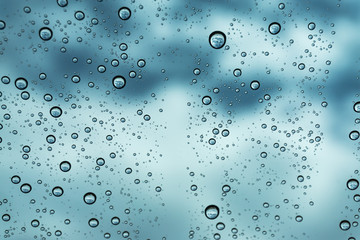 Rain on the window, natural skin of the rain The natural form of rainwater on a sky background.