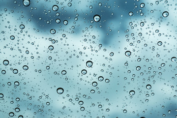 Rain on the window, natural skin of the rain The natural form of rainwater on a sky background.