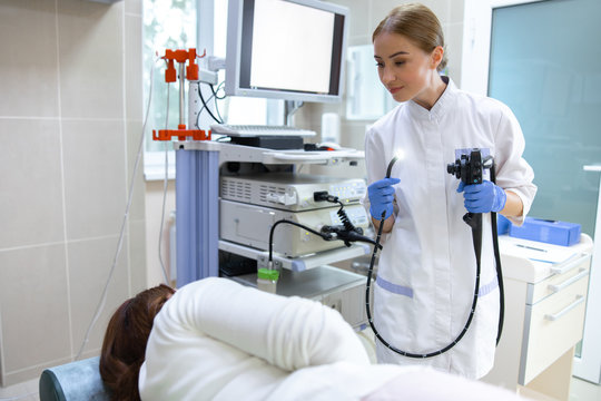 Young woman examining patient with digital machine stock photo