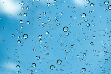 Rain on the window, natural skin of the rain The natural form of rainwater on a sky background.