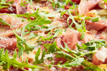 Tasty parma ham and artichoke pizza closeup