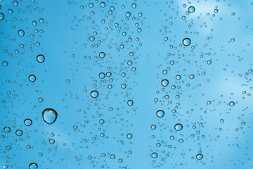 Rain on the window, natural skin of the rain The natural form of rainwater on a sky background.
