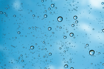 Rain on the window, natural skin of the rain The natural form of rainwater on a sky background.