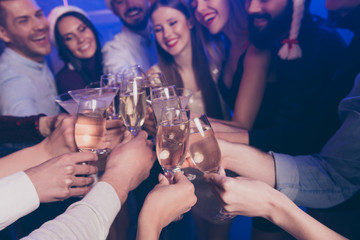 Cropped close-up view of nice attractive cheerful cheery positive girls and guys having fun rest relax clinking wineglass congrats winter December in luxury place nightclub indoors