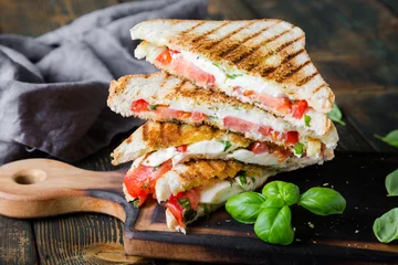 Foto auf Acrylglas Sandwiches with mozzarella, basil and tomatoes. Italian sandwich © Ruslan Mitin