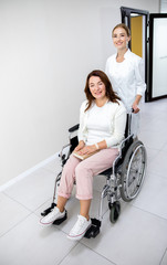 Disabled woman and nurse in clinic stock photo