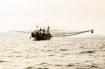 Bamar traditional fishing boat in Andaman Sea at dusk.