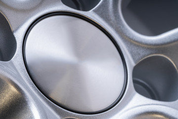 cast p aluminum wheel cover for car close up, copyspace