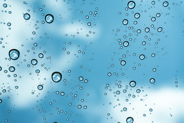 Rain on the window, natural skin of the rain The natural form of rainwater on a sky background.