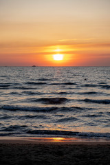 Red-orange sunset on the sea with a prominent sailing yacht on the horizon.  Bright colors of sea sunset.