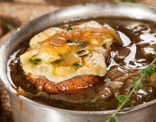 Onion soup with dried bread and cheddar cheese