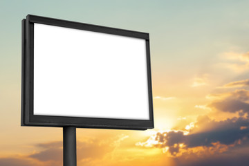 Blank billboard against cloudy sky at sunset