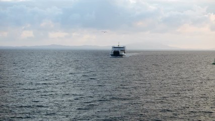 Ferryboat sailing the Mediterranean sea against the background of picturesque mountains. Greece. 4K