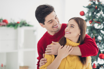 Close up photo of romantic romance spouses hug piggyback enjoy christmas atmosphere on x-mas jolly holidays feel affectionate in house with newyear decoration indoors