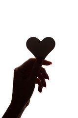 Symbol of heart and love in female hand - silhouette, isolated