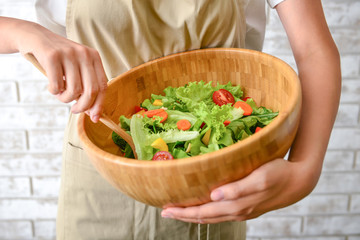 Woman preparing tasty salad, closeup