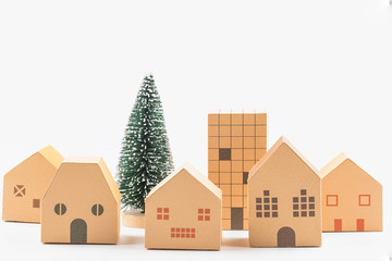 Tiny christmas tree and paper house toy isolated on white background.