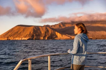 Foto op Canvas Cruise ship tourist on boat looking at sunset nature landscape in Galapagos Islands. © Maridav