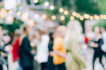 Blurred background. Blurred background on the street with lights-lanterns. Street festival.