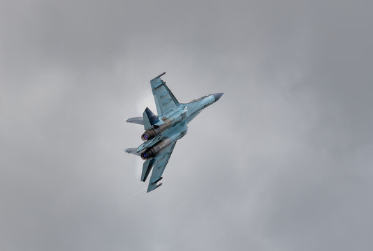 Su 35 fighter on a background of gray clouds.
