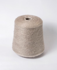 Fototapeta na wymiar bobbin of yarn on a white background. Side view.Textile reel on isolated white background.