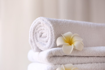Obraz na płótnie Canvas Clean towels with flowers, closeup