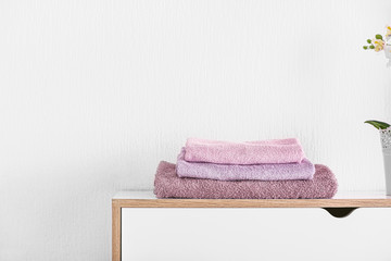 Stack of clean towels on table in room