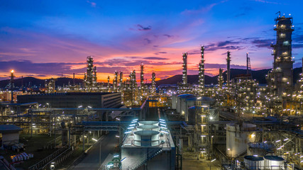 Oil​ refinery​ with oil storage tank and petrochemical​ plant industrial background at...