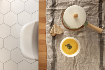 pumpkin cream soup with pumpkin seeds and bread