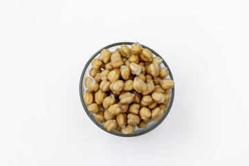 Boiled chickpea in a transparent bowl on white background, concept is healthy eating, horizontal orientation, top view