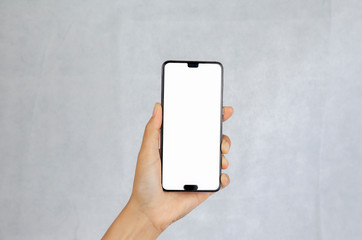 Hand holding the black smartphone with blank screen isolated on white background with clipping path....
