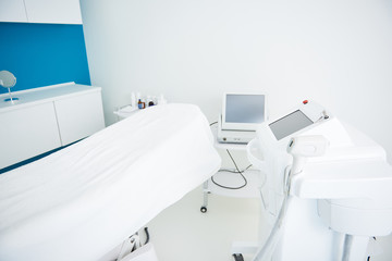 Interior of cosmetologist cabinet with epilation equipment in beauty salon