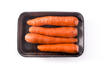 Carrots packaged in plastic isolated on white background. Top view