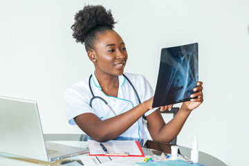 Woman doctor in hospital looking at x-ray film healthcare, roentgen, people and medicine concept....