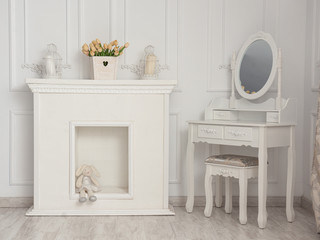 Beautiful white room with fireplace and table with mirror.
