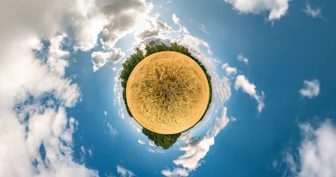 Little planet Transformation with curvature of space. Abstract torsion and spinning of full flyby panorama among fields in sunny evening with awesome clouds 