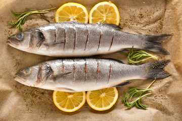 Fresh sea bass with spices and lemon on parchment