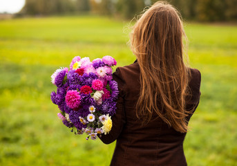 woman hold a big bouquet of Aster flowers