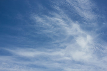 Blue sky with wispy white clouds
