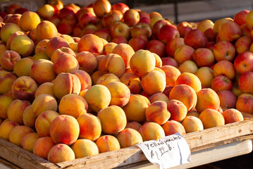 Peaches and Apples at an Outdoor Market