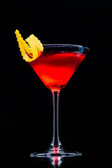 Cosmopolitan classic cocktail with reflection on a dark background