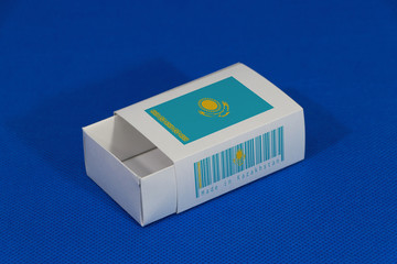 Kazakhstan flag on white box with barcode and the color of nation flag on blue background, paper packaging for put match or products.