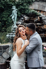 So happy. Beautiful boy kissing his girlfriend on the cheek. Love concept. Portrait of romantic couple touching and kissing each other. Love story. Couple in love.