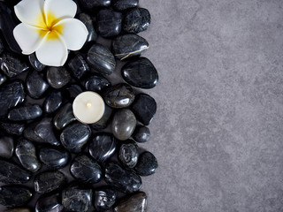 Black river rocks on gray marble background.