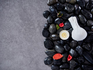 Herbal compress ball placed on black stone.
