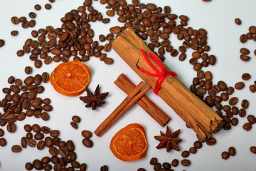 Coffee beans, cinnamon sticks, allspice and anise. Slices of dried oranges. On white background. World Coffee Day.