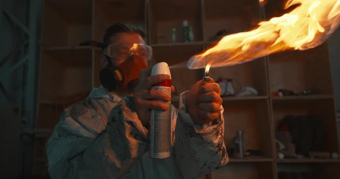 man splashes a flame of fire from a spray can