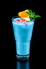 classic blue hawaii cocktail with reflection on dark background