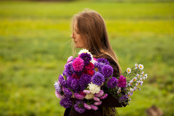 Fototapeta premium woman hold a big bouquet of Aster flowers