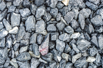 Small rocks or gravel made from  stones different shape as stone texture. Used for construction of buildings and roads and as a building material.